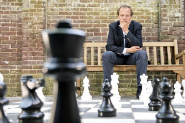 man contemplating chess board